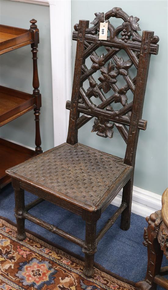 A 19th century Black Forest oak chair, with rustic trellis and grapevine back, the solid carved basket seat on rustic legs and H.100cm